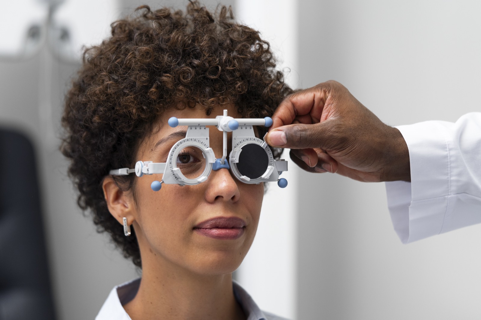 Optometrist adjusting a trial frame during an eye test